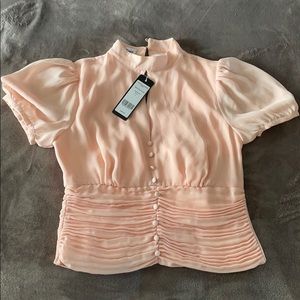 Pale blush Bebe blouse with shirred waist